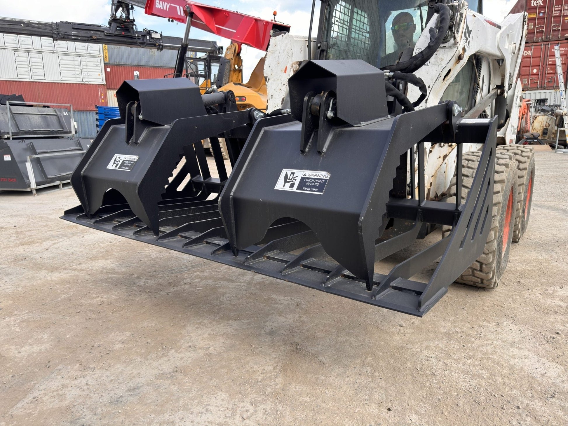 72" hydraulic grapple bucket on skid steer

Skid steer rock grapple front view

Close-up of grapple teeth and hoses

Dual-cylinder grapple open position

Grapple attachment lifting heavy debris