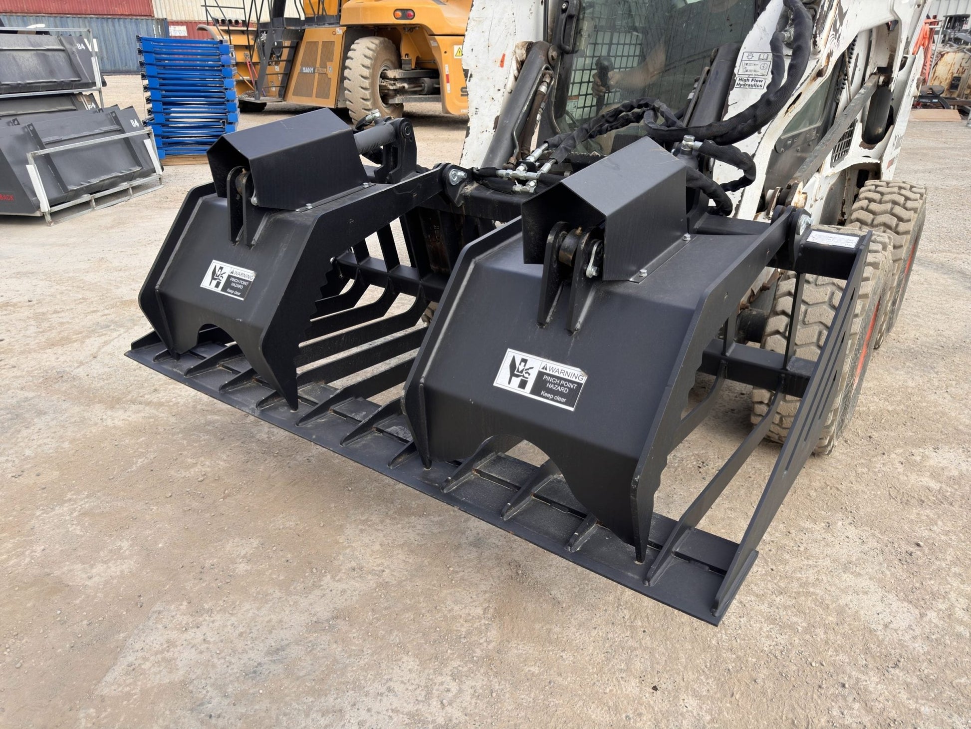 72" hydraulic grapple bucket on skid steer

Skid steer rock grapple front view

Close-up of grapple teeth and hoses

Dual-cylinder grapple open position

Grapple attachment lifting heavy debris