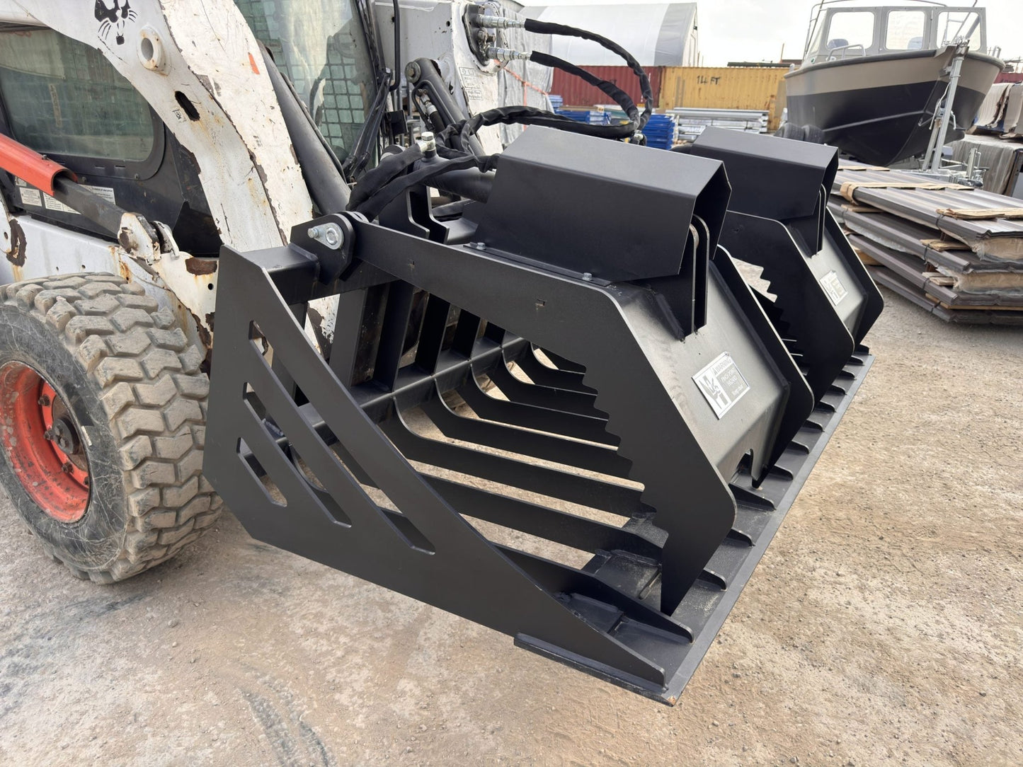 72" hydraulic grapple bucket on skid steer

Skid steer rock grapple front view

Close-up of grapple teeth and hoses

Dual-cylinder grapple open position

Grapple attachment lifting heavy debris