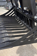 72" hydraulic grapple bucket on skid steer

Skid steer rock grapple front view

Close-up of grapple teeth and hoses

Dual-cylinder grapple open position

Grapple attachment lifting heavy debris