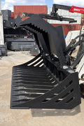 72" hydraulic grapple bucket on skid steer

Skid steer rock grapple front view

Close-up of grapple teeth and hoses

Dual-cylinder grapple open position

Grapple attachment lifting heavy debris