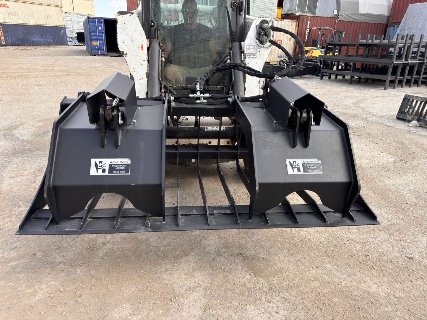 72" hydraulic grapple bucket on skid steer

Skid steer rock grapple front view

Close-up of grapple teeth and hoses

Dual-cylinder grapple open position

Grapple attachment lifting heavy debris