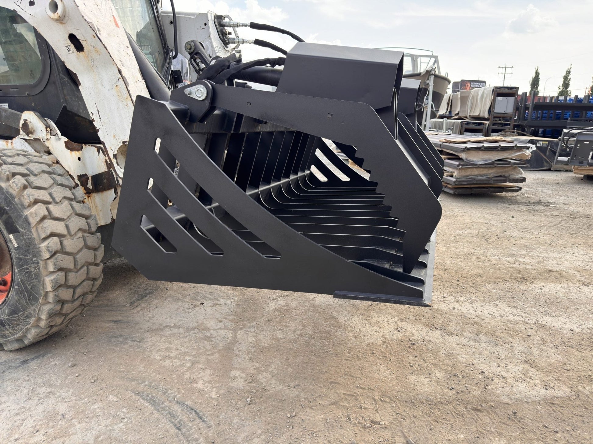 72" hydraulic grapple bucket on skid steer

Skid steer rock grapple front view

Close-up of grapple teeth and hoses

Dual-cylinder grapple open position

Grapple attachment lifting heavy debris