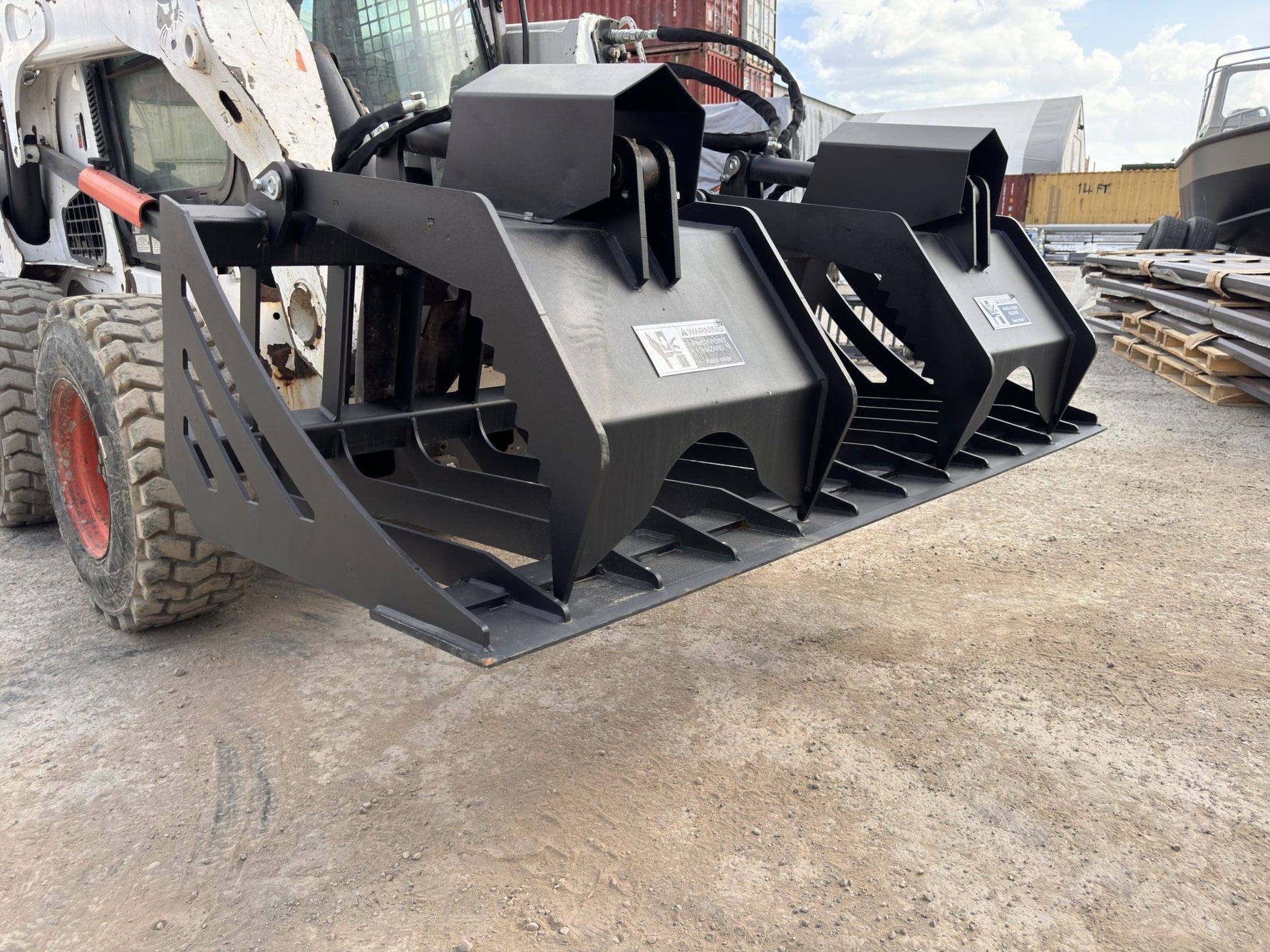 72" hydraulic grapple bucket on skid steer

Skid steer rock grapple front view

Close-up of grapple teeth and hoses

Dual-cylinder grapple open position

Grapple attachment lifting heavy debris