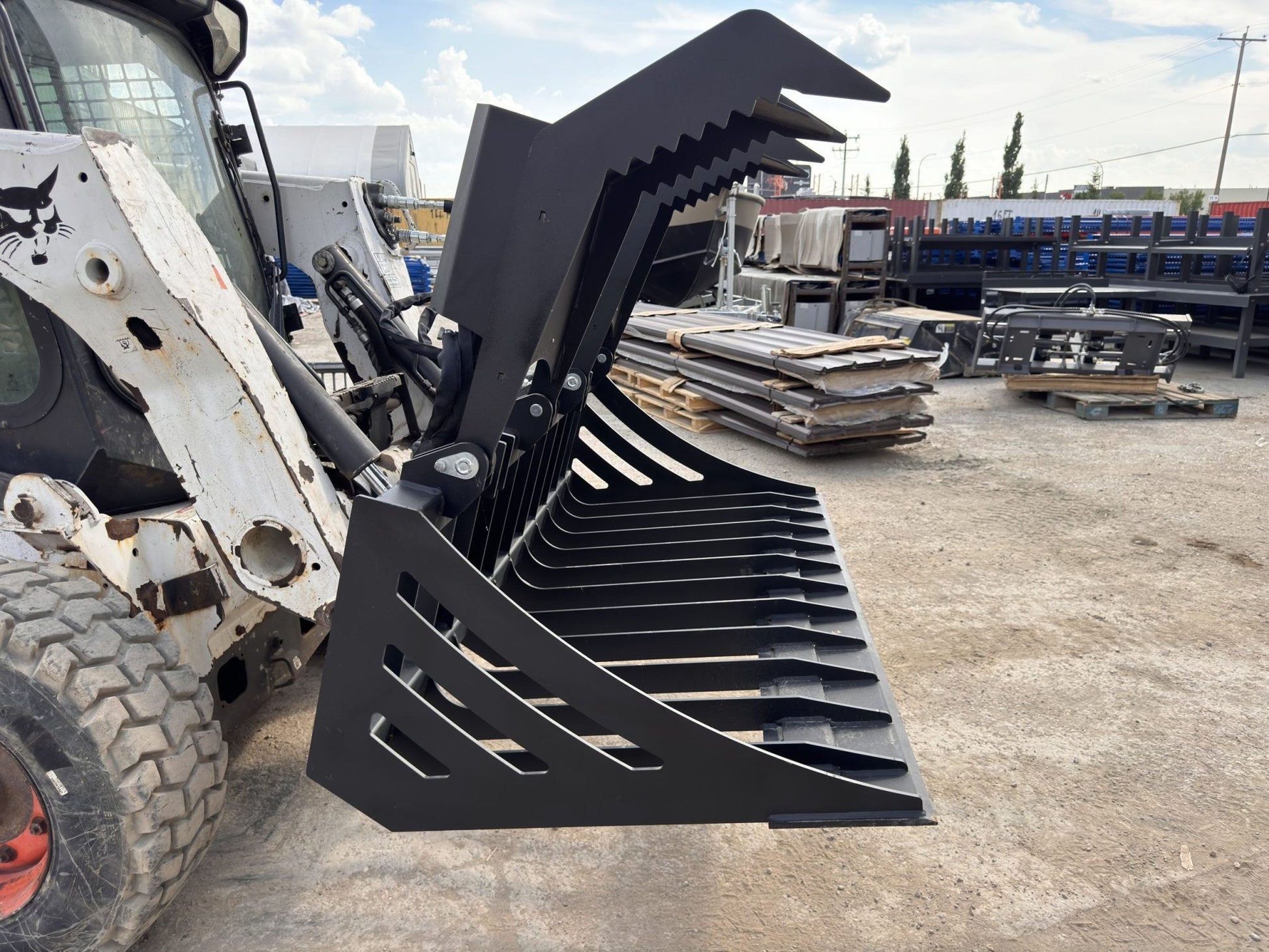 72" hydraulic grapple bucket on skid steer

Skid steer rock grapple front view

Close-up of grapple teeth and hoses

Dual-cylinder grapple open position

Grapple attachment lifting heavy debris