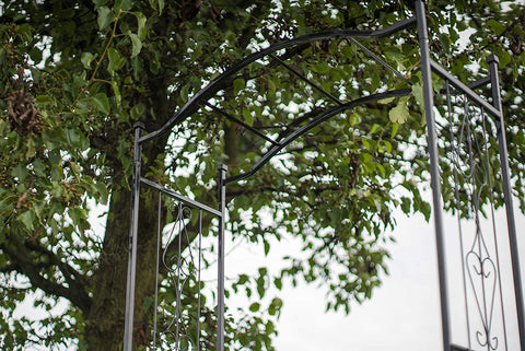 Black steel garden arbor arch in the outdoor lawn

Powder-coated metal trellis arch with decorative side panels

77-inch outdoor wedding arch for garden ceremonies

Steel arbor for roses and climbing vines

Decorative garden arch black steel frame assembled in the yard