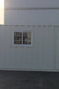 Gray 7FT steel office container with side door and windows
Interior view of 12FT jobsite office sea container
Office container unit with swing door and locking system
Plywood flooring inside portable office container
Security window with locking bar on steel sea container