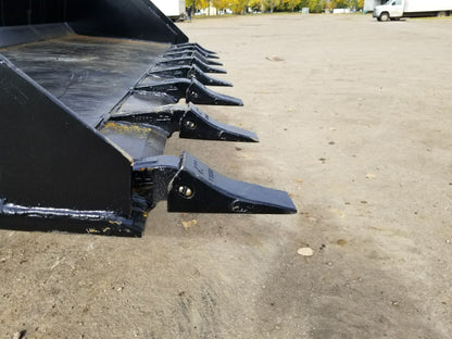80" skid steer digging bucket with removable teeth

Heavy-duty bucket on job site with loader

Front view of 84-inch skid steer bucket

Skid steer digging into dirt with steel bucket

Wear strips and teeth close-up for material handling