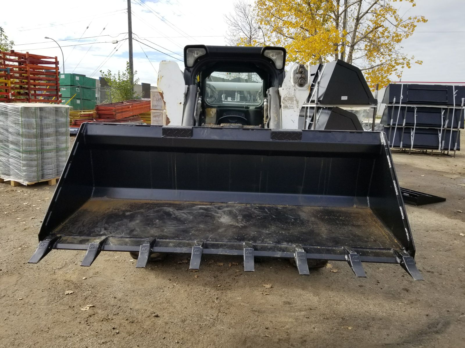 80" skid steer digging bucket with removable teeth

Heavy-duty bucket on job site with loader

Front view of 84-inch skid steer bucket

Skid steer digging into dirt with steel bucket

Wear strips and teeth close-up for material handling