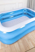 80 inch inflatable swimming pool – full top view

Inflated blue family pool on backyard grass

Folded pool with included storage bag

Kids splashing in inflatable rectangular pool

Side view of inflated rectangular pool