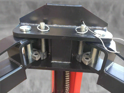 Red 2-post car hoist installed in garage

Close-up of safety lock and lift arms

Base of the lift showing manual release system

Top bar and symmetrical arm configuration