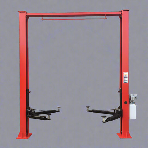 Red 2-post car hoist installed in garage

Close-up of safety lock and lift arms

Base of the lift showing manual release system

Top bar and symmetrical arm configuration