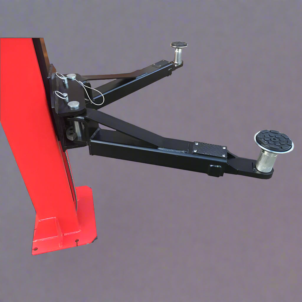 Red 2-post car hoist installed in garage

Close-up of safety lock and lift arms

Base of the lift showing manual release system

Top bar and symmetrical arm configuration
