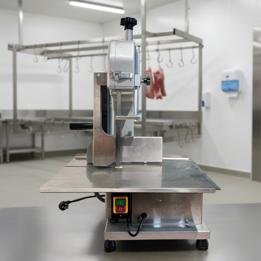 Full front view of a commercial frozen meat and bone saw machine
Side angle of a stainless steel cutting saw in a commercial kitchen
Bone saw machine in use, cutting frozen meat
Operator slicing frozen beef bones with an electric meat saw
Commercial food processing bone cutting equipment in operation
Close-up of adjustable blade on automatic bone saw