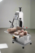 Full front view of a commercial frozen meat and bone saw machine
Side angle of a stainless steel cutting saw in a commercial kitchen
Bone saw machine in use, cutting frozen meat
Operator slicing frozen beef bones with an electric meat saw
Commercial food processing bone cutting equipment in operation
Close-up of adjustable blade on automatic bone saw