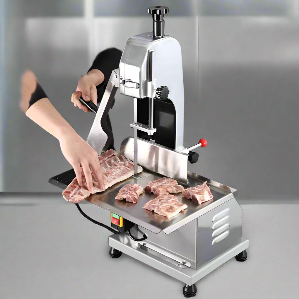Full front view of a commercial frozen meat and bone saw machine
Side angle of a stainless steel cutting saw in a commercial kitchen
Bone saw machine in use, cutting frozen meat
Operator slicing frozen beef bones with an electric meat saw
Commercial food processing bone cutting equipment in operation
Close-up of adjustable blade on automatic bone saw