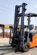 CanLift 4000 LBS orange electric forklift with 118” lift and 42” forks
Profile shot of forklift with raised mast and battery housing
Rear view of forklift with control panel and operator seat
42” heavy-duty forks and solid tires
Close-up of fork shifting mechanism