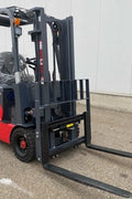 CanLift 4000 LBS orange electric forklift with 118” lift and 42” forks
Profile shot of forklift with raised mast and battery housing
Rear view of forklift with control panel and operator seat
42” heavy-duty forks and solid tires
Close-up of fork shifting mechanism