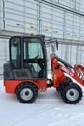 CanLift EREL10 electric wheel loader side view
Red electric wheel loader lifting materials
Bobcat-style quick hitch on CanLift loader
72V battery electric loader in warehouse
Heavy-duty compact loader with bucket attachment