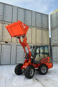 CanLift Mini Wheel Loader with Kubota D1703 engine, orange color – front view
Side view of CanLift compact loader with closed cabin and bucket raised
CanLift mini loader in operation – orange machine on construction site