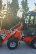 CanLift Mini Wheel Loader with Kubota D1703 engine
Orange and gray wheel loader with enclosed cabin
Compact loader with quick hitch and bucket
Mini loader for snow removal and landscaping
Hydrostatic drive mini loader with joystick control
