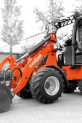 CanLift Mini Wheel Loader with Kubota D1703 engine, orange color – front view
Side view of CanLift compact loader with closed cabin and bucket raised
CanLift mini loader in operation – orange machine on construction site