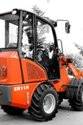 CanLift Mini Wheel Loader with Kubota D1703 engine, orange color – front view
Side view of CanLift compact loader with closed cabin and bucket raised
CanLift mini loader in operation – orange machine on construction site