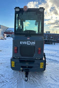 CanLift Mini Wheel Loader with Kubota D1703 engine, orange color – front view
Side view of CanLift compact loader with closed cabin and bucket raised
CanLift mini loader in operation – orange machine on construction site