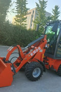 CanLift Mini Wheel Loader with Kubota D1703 engine
Orange and gray wheel loader with enclosed cabin
Compact loader with quick hitch and bucket
Mini loader for snow removal and landscaping
Hydrostatic drive mini loader with joystick control