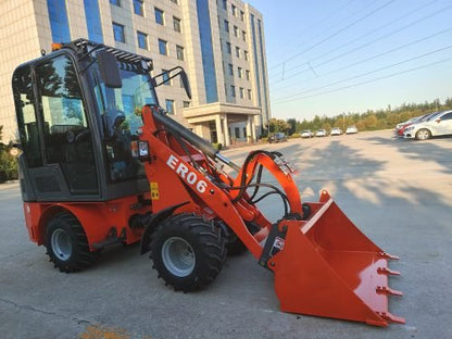 CanLift Mini Wheel Loader with Kubota D1703 engine
Orange and gray wheel loader with enclosed cabin
Compact loader with quick hitch and bucket
Mini loader for snow removal and landscaping
Hydrostatic drive mini loader with joystick control