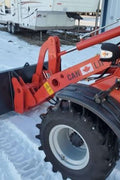 CanLift W12 Mini Wheel Loader with Kohler diesel engine outside a facility
Side view of CanLift W12 loader equipped with bucket attachment
Compact CanLift W12 Wheel Loader used on farm site