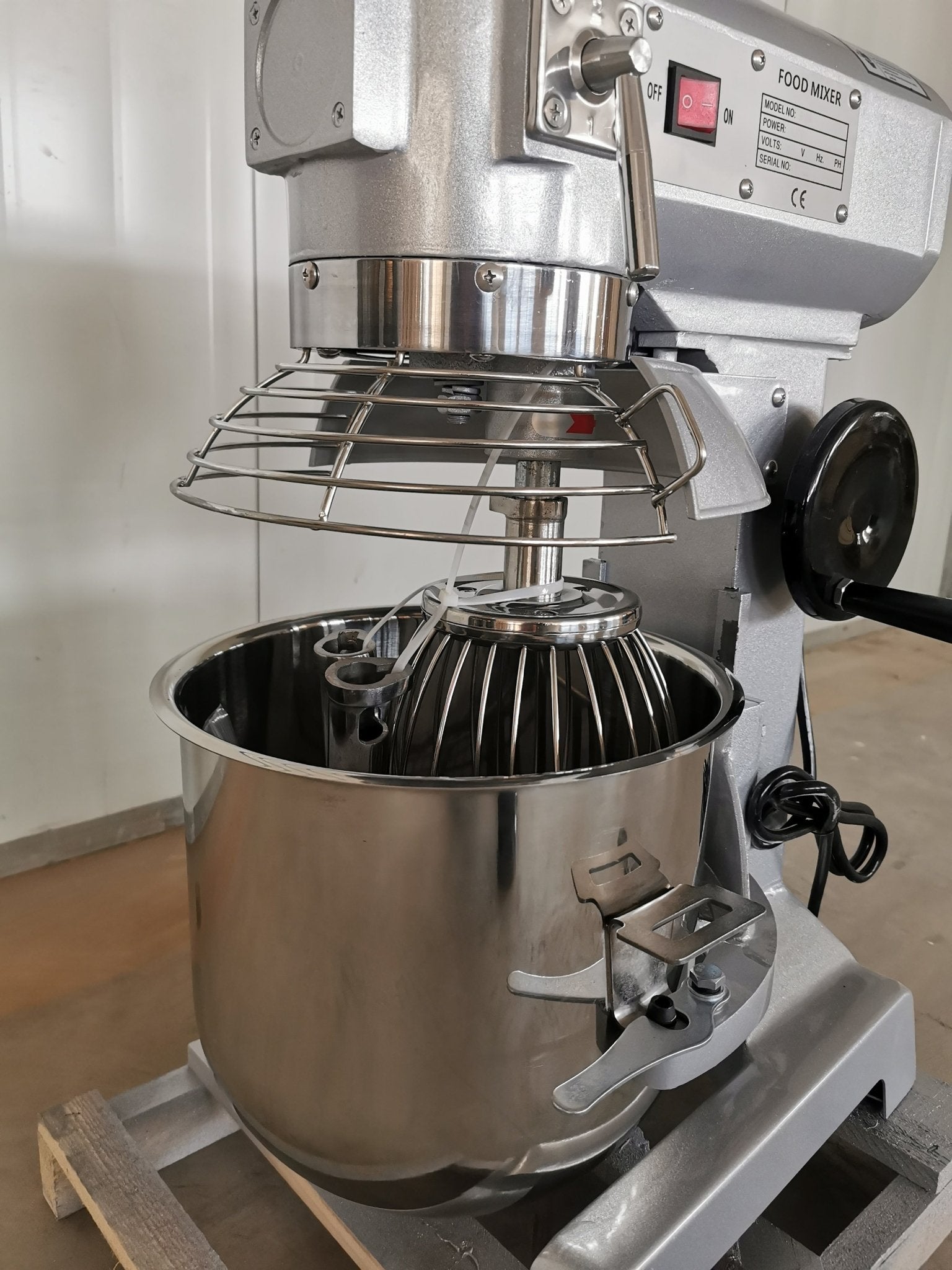 15 QT commercial dough mixer on stainless steel counter

Stainless steel mixing bowl with guard closed

Front view of food-grade commercial mixer with attachments

Dough hook installed on industrial kitchen mixer