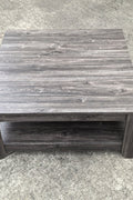 Dark gray oak square coffee table styled in a modern living room
Close-up of woodgrain texture and lower shelf
Angled view of the full table with storage items
The coffee table is placed with decorative accessories
Dark oak coffee table with books and a remote on the shelf
