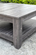 Dark gray oak square coffee table styled in a modern living room
Close-up of woodgrain texture and lower shelf
Angled view of the full table with storage items
The coffee table is placed with decorative accessories
Dark oak coffee table with books and a remote on the shelf