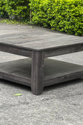Dark gray oak square coffee table styled in a modern living room
Close-up of woodgrain texture and lower shelf
Angled view of the full table with storage items
The coffee table is placed with decorative accessories
Dark oak coffee table with books and a remote on the shelf
