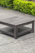 Dark gray oak square coffee table styled in a modern living room
Close-up of woodgrain texture and lower shelf
Angled view of the full table with storage items
The coffee table is placed with decorative accessories
Dark oak coffee table with books and a remote on the shelf