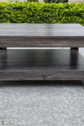 Dark gray oak square coffee table styled in a modern living room
Close-up of woodgrain texture and lower shelf
Angled view of the full table with storage items
The coffee table is placed with decorative accessories
Dark oak coffee table with books and a remote on the shelf