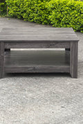 Dark gray oak square coffee table styled in a modern living room
Close-up of woodgrain texture and lower shelf
Angled view of the full table with storage items
The coffee table is placed with decorative accessories
Dark oak coffee table with books and a remote on the shelf