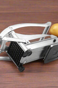 Stainless steel French fry cutter with 2 blades model 431012
Heavy-duty fry cutter with suction base and lever handle
Restaurant-quality potato slicer with thick and thin cut blades