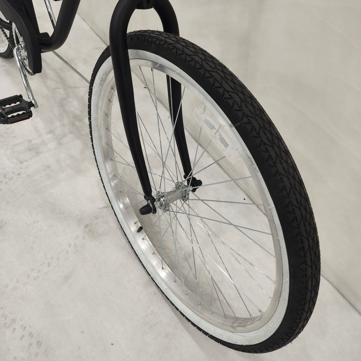 Side view of Deviant 26" beach cruiser bicycle in matte black

Close-up of comfort seat and handlebar grips

Rear coaster brake and single-speed drivetrain

Full assembled view of the Deviant black cruiser bike

Cruiser bike parked on a path at sunset