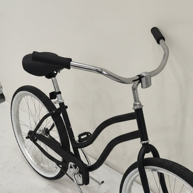 Side view of Deviant 26" beach cruiser bicycle in matte black

Close-up of comfort seat and handlebar grips

Rear coaster brake and single-speed drivetrain

Full assembled view of the Deviant black cruiser bike

Cruiser bike parked on a path at sunset