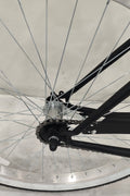 Side view of Deviant 26" beach cruiser bicycle in matte black

Close-up of comfort seat and handlebar grips

Rear coaster brake and single-speed drivetrain

Full assembled view of the Deviant black cruiser bike

Cruiser bike parked on a path at sunset
