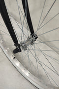 Side view of Deviant 26" beach cruiser bicycle in matte black

Close-up of comfort seat and handlebar grips

Rear coaster brake and single-speed drivetrain

Full assembled view of the Deviant black cruiser bike

Cruiser bike parked on a path at sunset