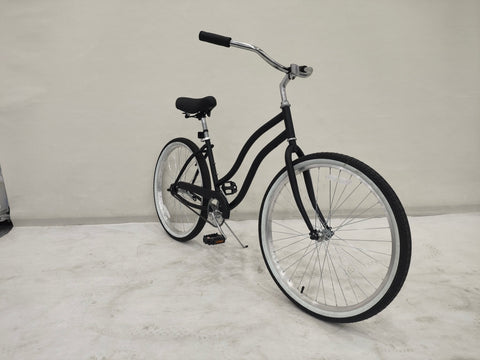 Side view of Deviant 26" beach cruiser bicycle in matte black

Close-up of comfort seat and handlebar grips

Rear coaster brake and single-speed drivetrain

Full assembled view of the Deviant black cruiser bike

Cruiser bike parked on a path at sunset