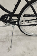 Side view of Deviant 26" beach cruiser bicycle in matte black

Close-up of comfort seat and handlebar grips

Rear coaster brake and single-speed drivetrain

Full assembled view of the Deviant black cruiser bike

Cruiser bike parked on a path at sunset