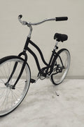 Side view of Deviant 26" beach cruiser bicycle in matte black

Close-up of comfort seat and handlebar grips

Rear coaster brake and single-speed drivetrain

Full assembled view of the Deviant black cruiser bike

Cruiser bike parked on a path at sunset