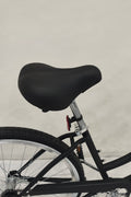 Side view of Deviant 26" beach cruiser bicycle in matte black

Close-up of comfort seat and handlebar grips

Rear coaster brake and single-speed drivetrain

Full assembled view of the Deviant black cruiser bike

Cruiser bike parked on a path at sunset