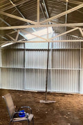 Double steel garage with roll-up doors, outdoor view

Interior view of metal garage barn frame

Roll-up electric overhead doors included in garage

Galvanized steel shed for vehicle and farm storage

Multiple-size all-weather garage options