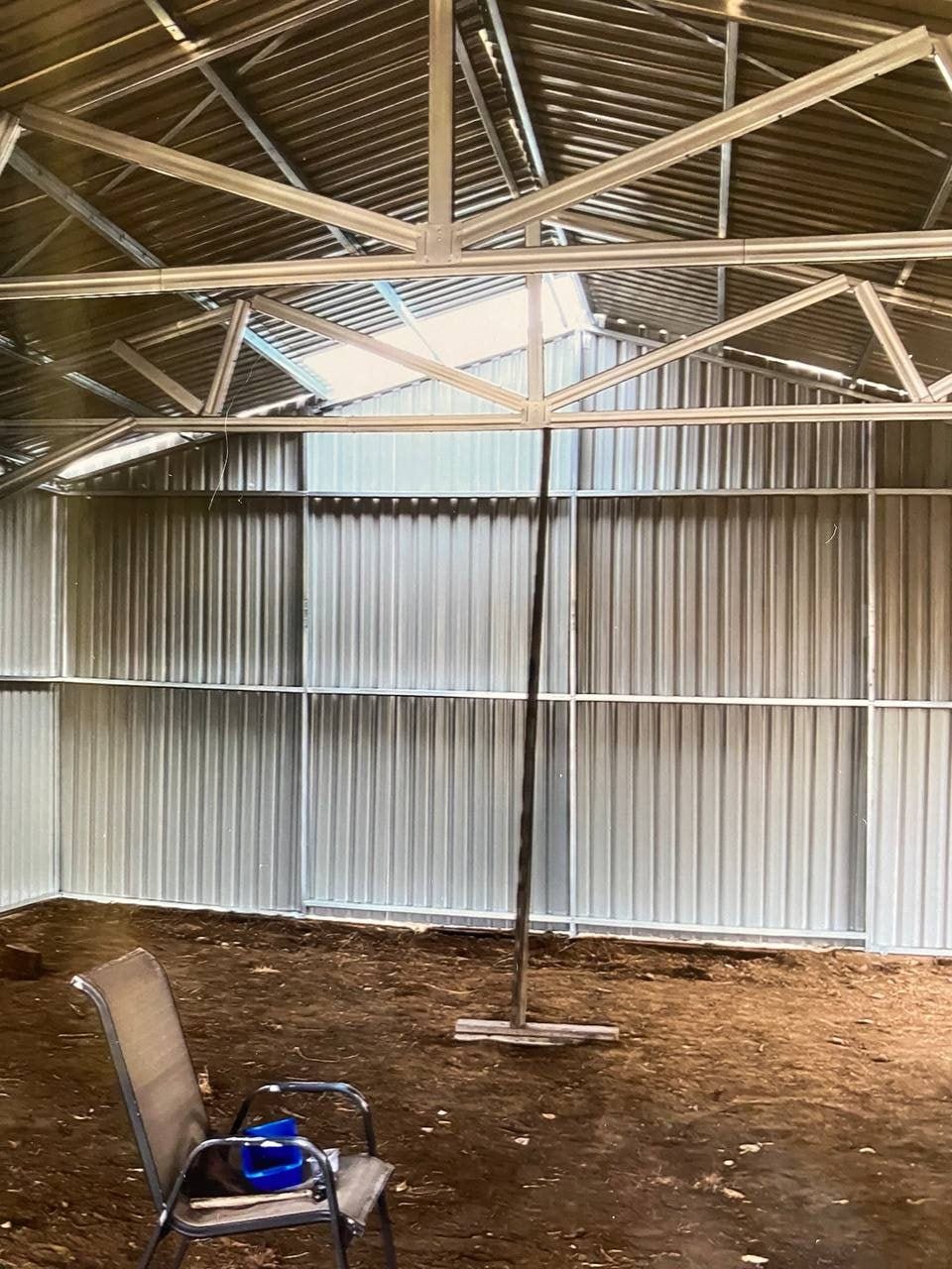 Double steel garage with roll-up doors, outdoor view

Interior view of metal garage barn frame

Roll-up electric overhead doors included in garage

Galvanized steel shed for vehicle and farm storage

Multiple-size all-weather garage options
