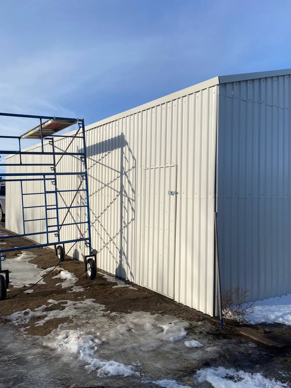 Double steel garage with roll-up doors, outdoor view

Interior view of metal garage barn frame

Roll-up electric overhead doors included in garage

Galvanized steel shed for vehicle and farm storage

Multiple-size all-weather garage options